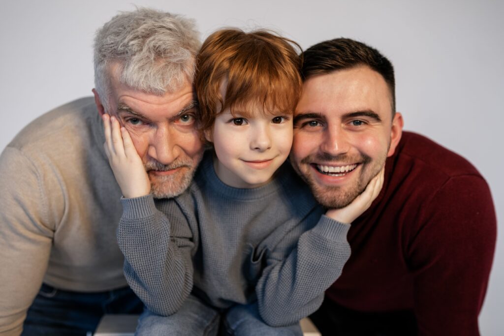 Three generations of a family sharing a moment, representing human relationships and memories across a lifetime.