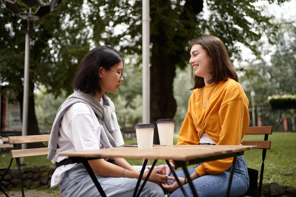 Two friends talking openly outdoors, representing healthy relationships and mutual respect.