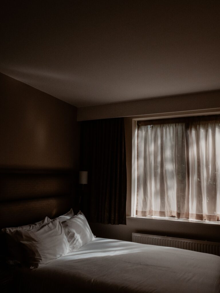 Moonlight entering a peaceful bedroom, symbolising a calmer mind before sleep.