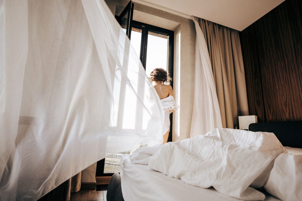 Feeling disconnected from yourself while reflecting quietly beside a window.