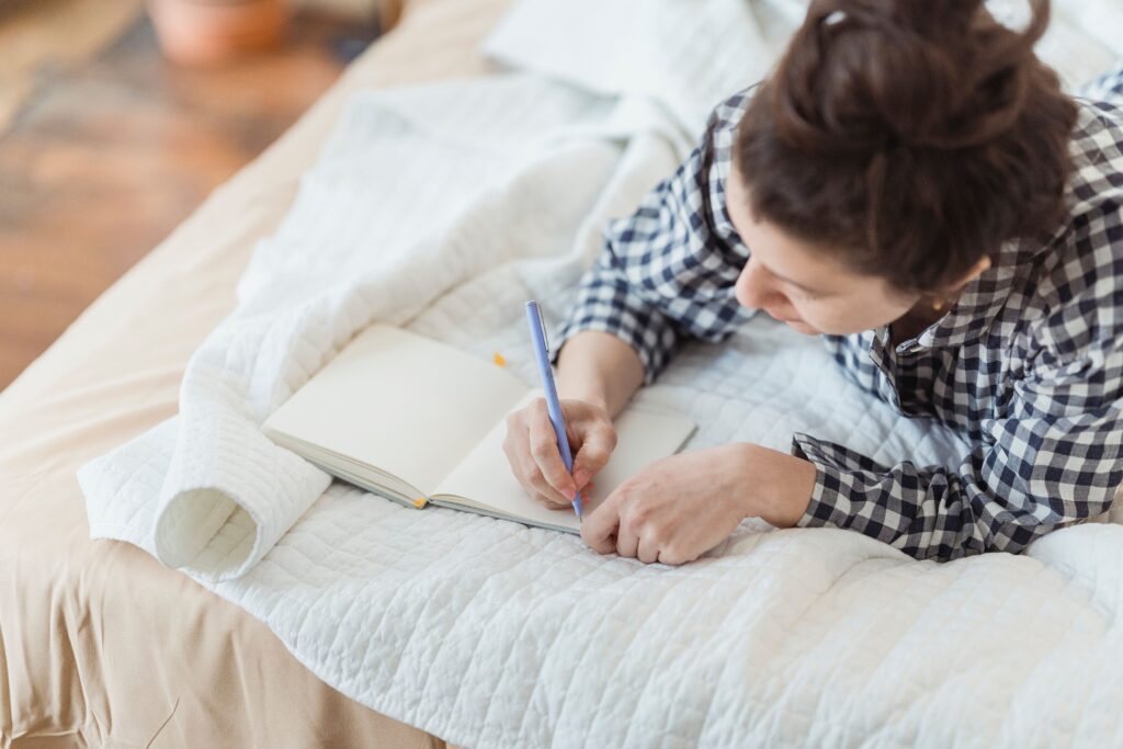 Person writing in a journal to understand their values and find direction in life.