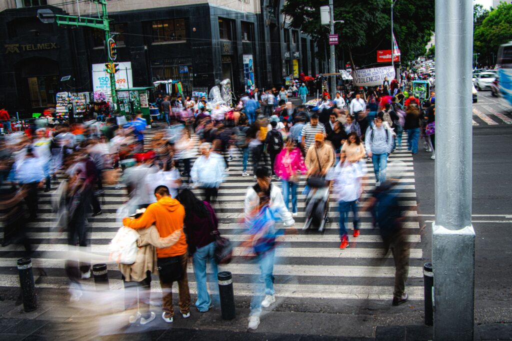 People moving through a busy city, representing repetitive routines and everyday distractions.