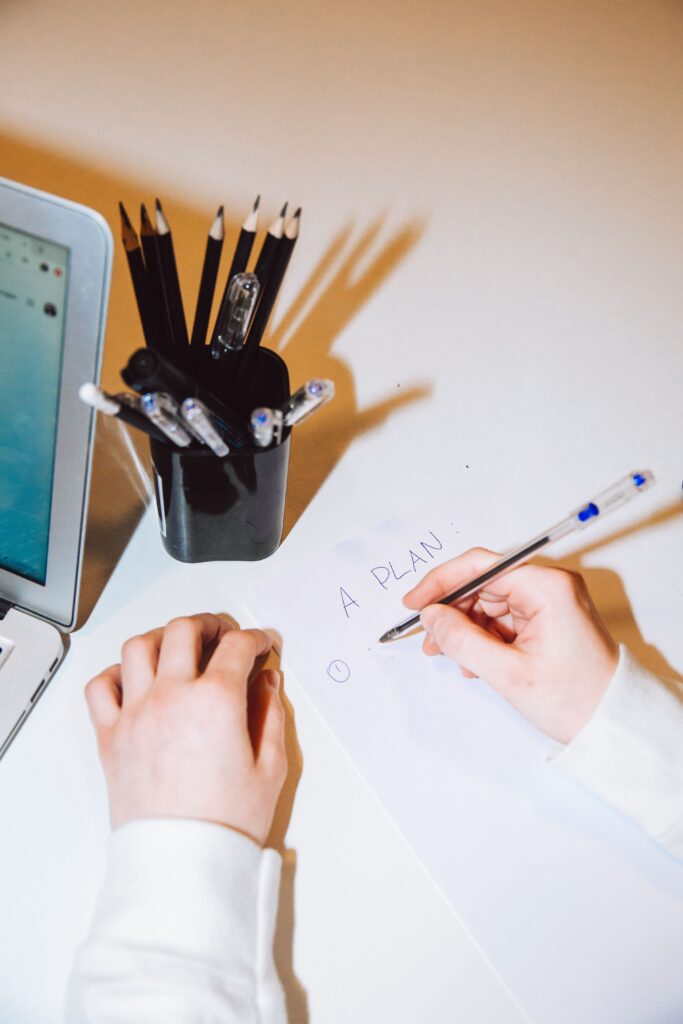 Open notebook and planning materials used to organise priorities before making a decision.
