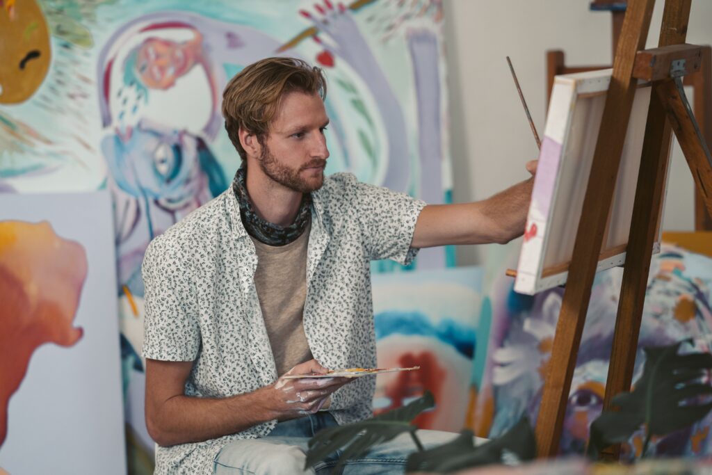 Person rediscovering creativity through painting as a way to reconnect with personal interests.