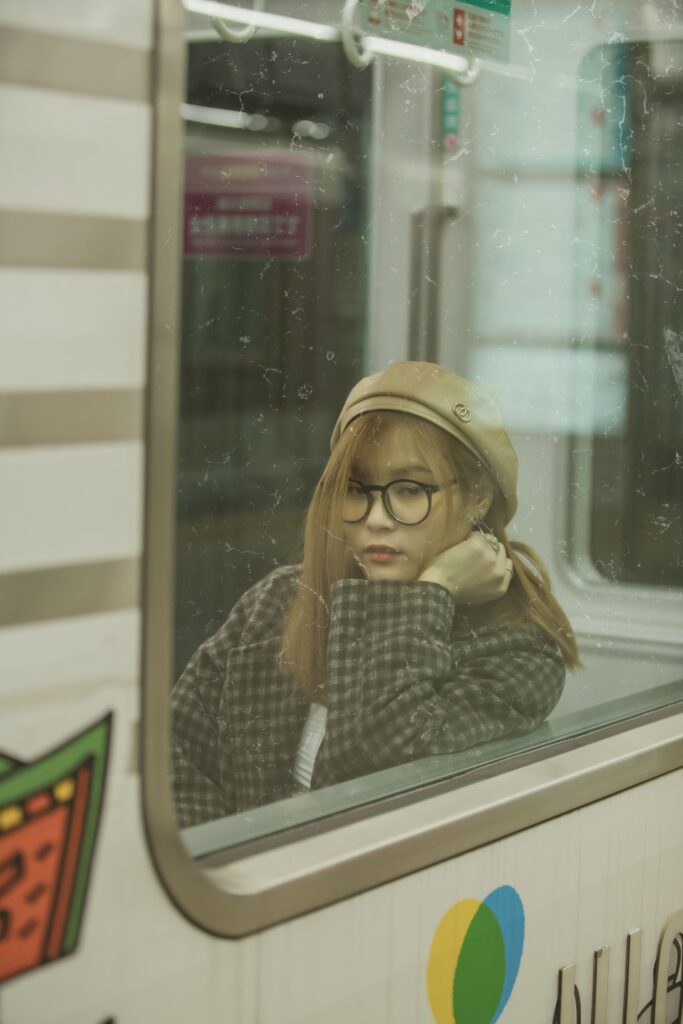 Person looking out of a train window while reflecting on why they are living on autopilot.